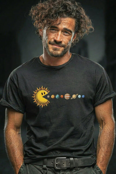 Man with curly brown hair and beard wearing black t-shirt featuring Pac-Man sun eating planets solar system graphic design