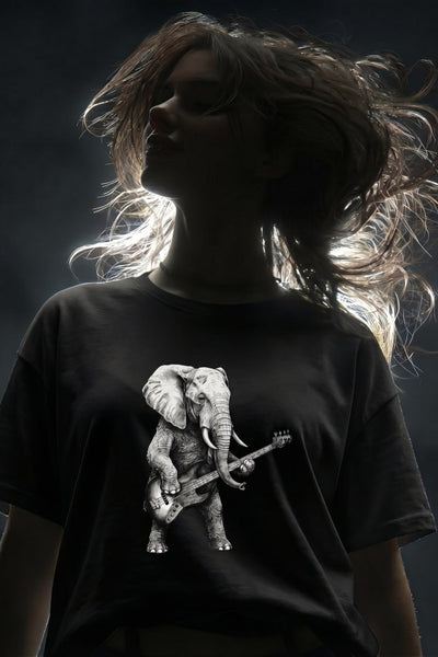 Woman with long flowing brown hair wearing black t-shirt featuring elephant playing bass guitar graphic design