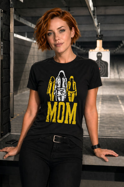 Woman with short red hair wearing black badass MOM t-shirt featuring tactical female silhouettes graphic