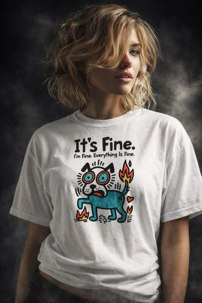 Woman with wavy blonde hair wearing white "It's Fine. I'm Fine. Everything Is Fine." t-shirt featuring stressed cartoon dog on fire meme graphic