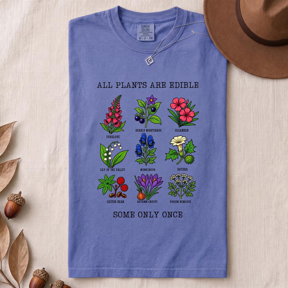 All Plants Are Edible Some Only Once Botanical Chart T-Shirt - Flo Blue folded t-shirt mockup