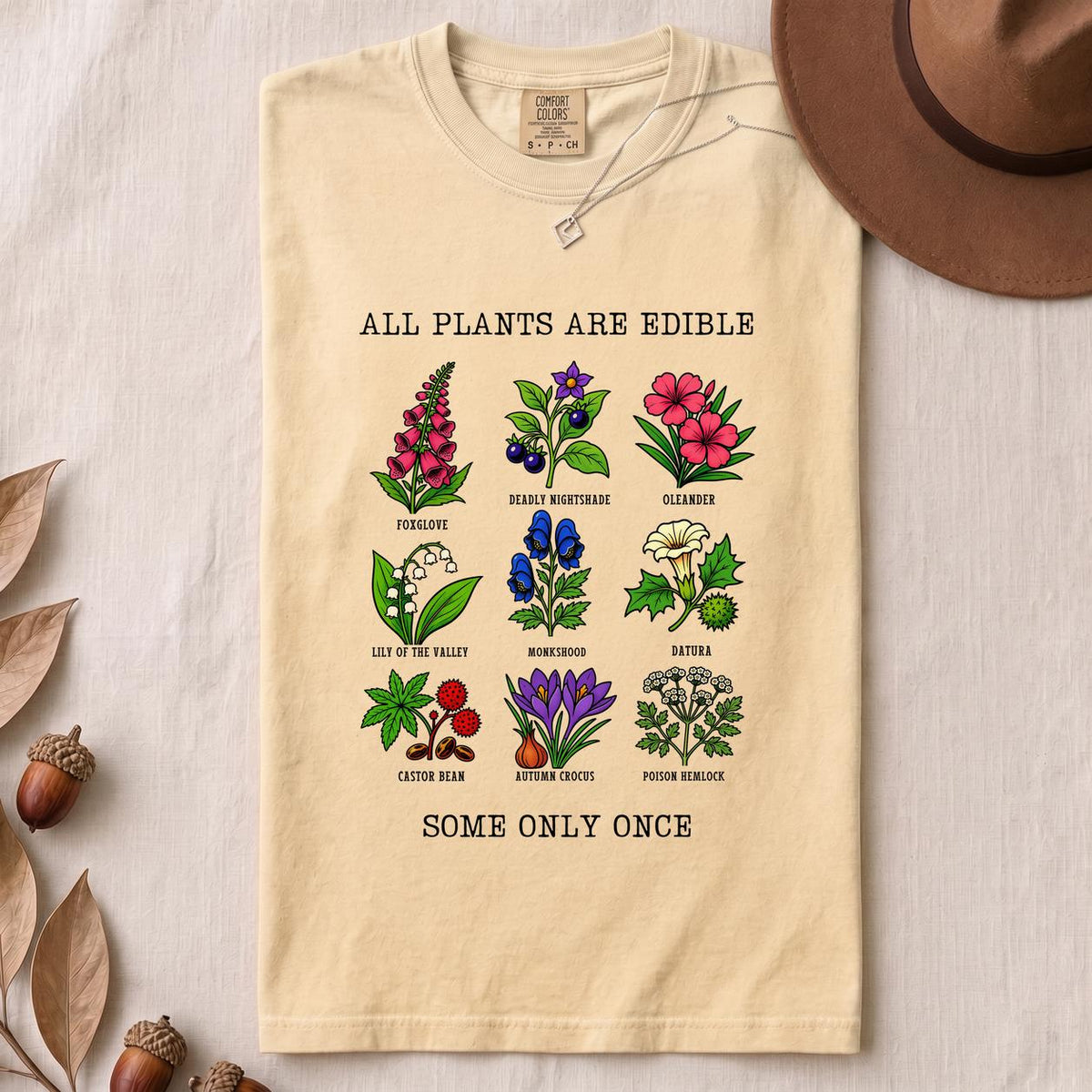 All Plants Are Edible Some Only Once Botanical Chart T-Shirt - Ivory folded t-shirt mockup