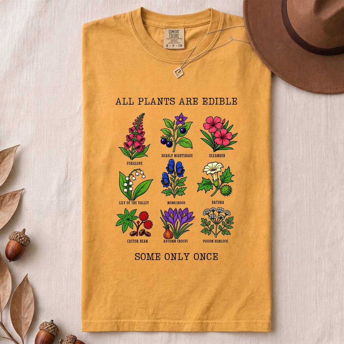 All Plants Are Edible Some Only Once Botanical Chart T-Shirt - Mustard folded t-shirt mockup