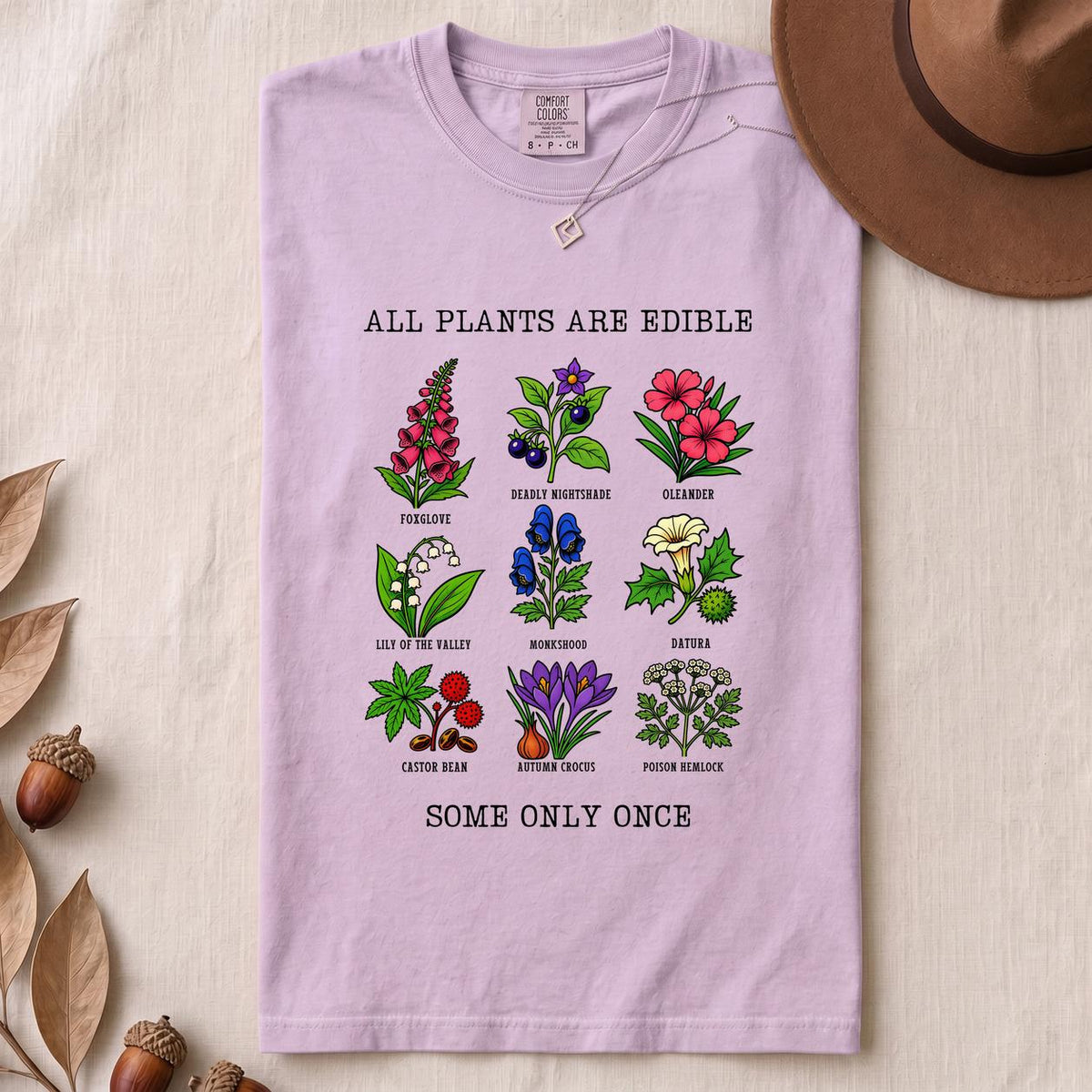 All Plants Are Edible Some Only Once Botanical Chart T-Shirt - Orchid folded t-shirt mockup