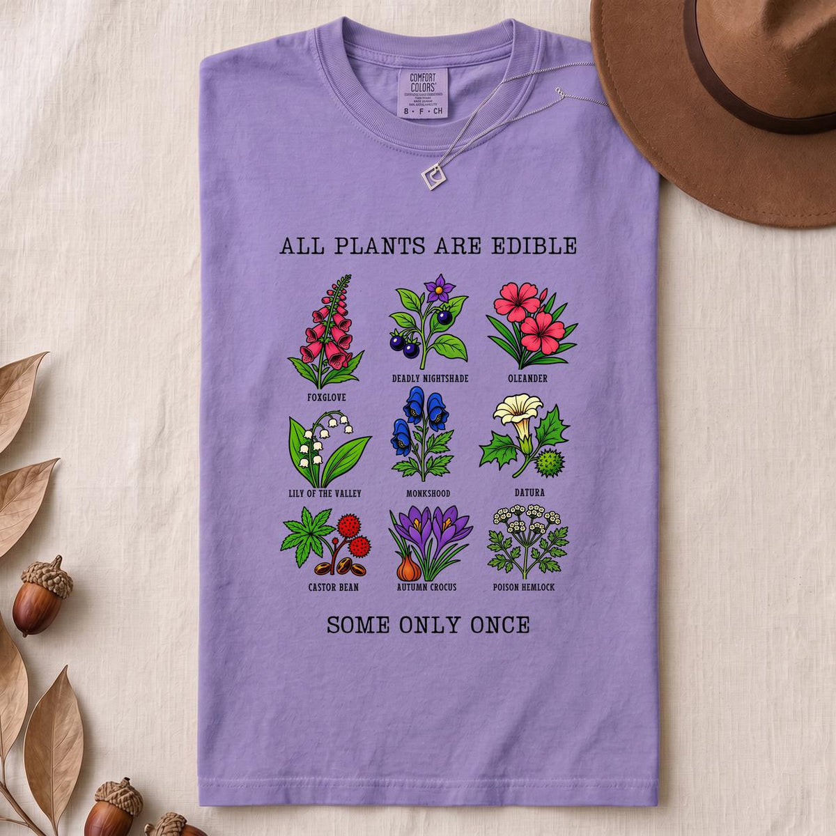 All Plants Are Edible Some Only Once Botanical Chart T-Shirt - Violet folded t-shirt mockup
