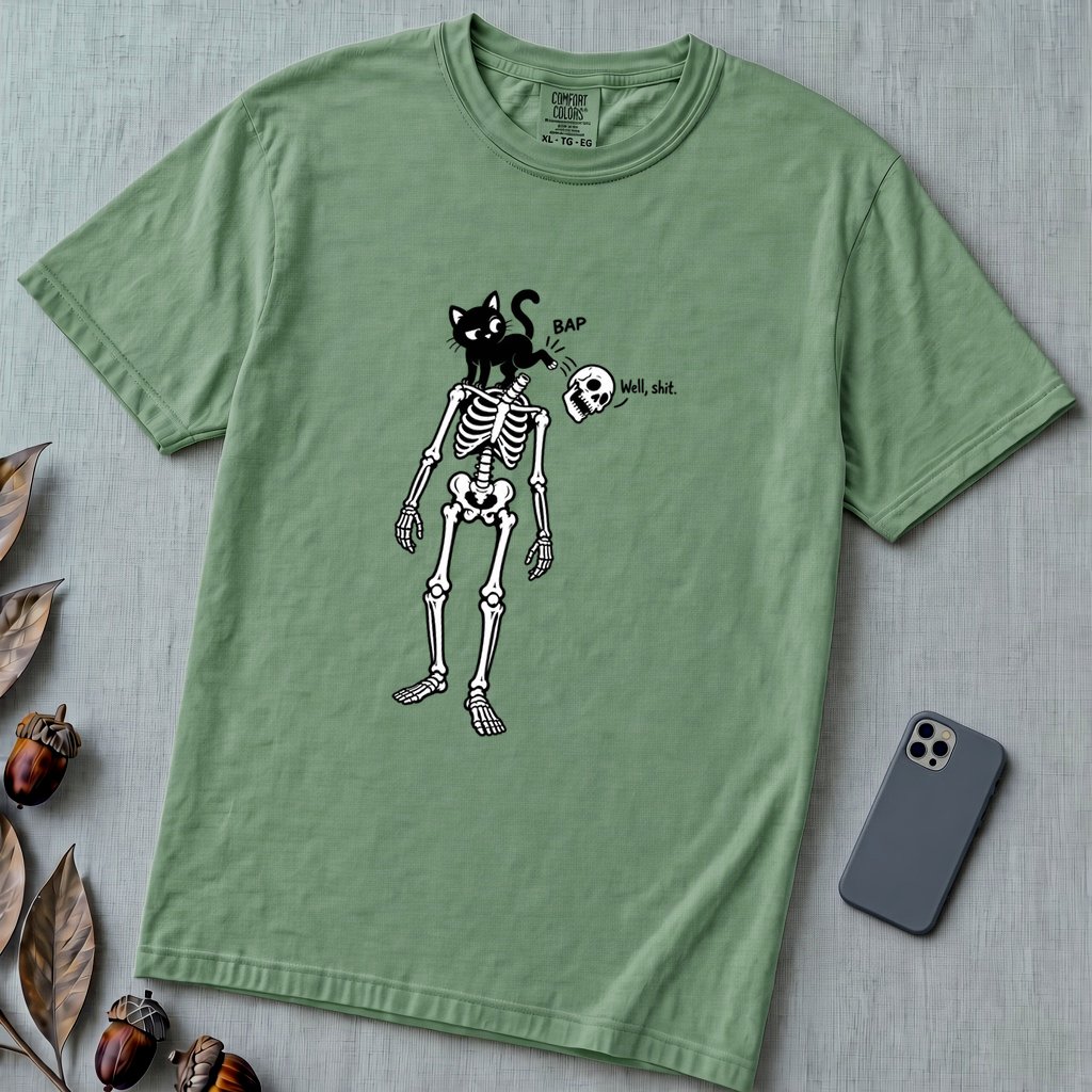 Cat Knocks Skull Off Graphic Tee, Black Cat vs Skeleton Funny T-Shirt - Light Green unfolded t-shirt mockup