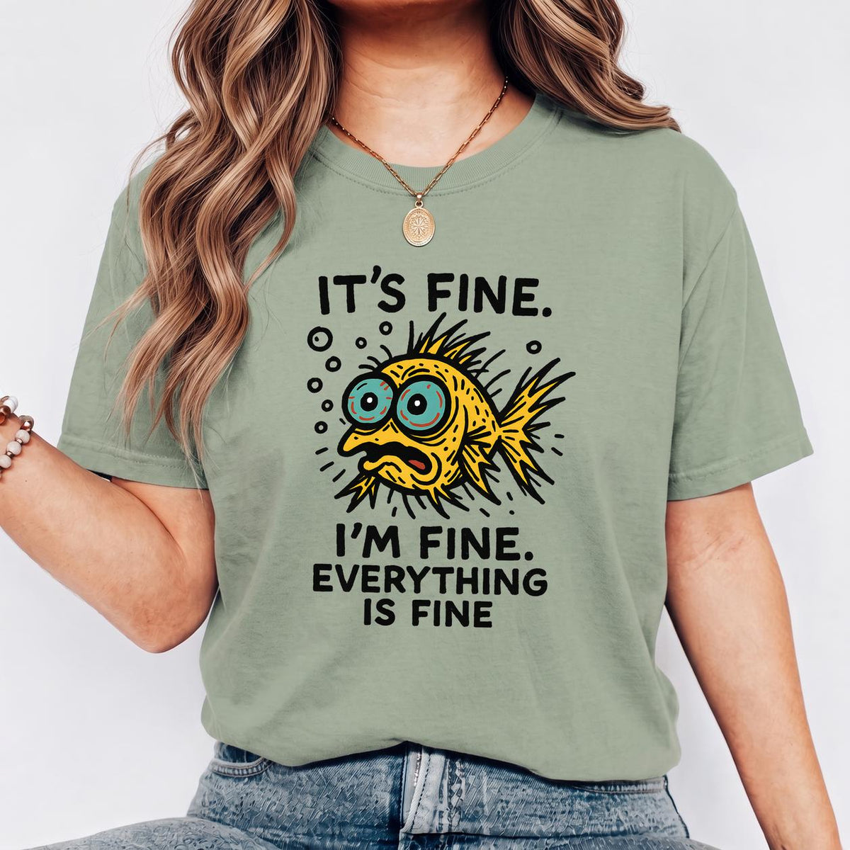 Funny Fish “It’s Fine” Mental Health Humor Sarcastic Panic Meme Tee - Sage on-model t-shirt mockup