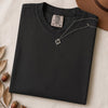 Just a t-shirt. Comfort Colors unisex garment-dyed heavyweight plain t-shirt with Radiant Art logo on right sleeve - Black folded t-shirt mockup