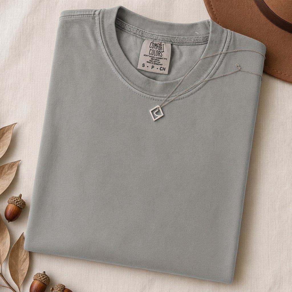 Just a t-shirt. Comfort Colors unisex garment-dyed heavyweight plain t-shirt with Radiant Art logo on right sleeve - Granite folded t-shirt mockup
