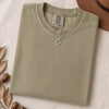 Just a t-shirt. Comfort Colors unisex garment-dyed heavyweight plain t-shirt with Radiant Art logo on right sleeve - Khaki folded t-shirt mockup