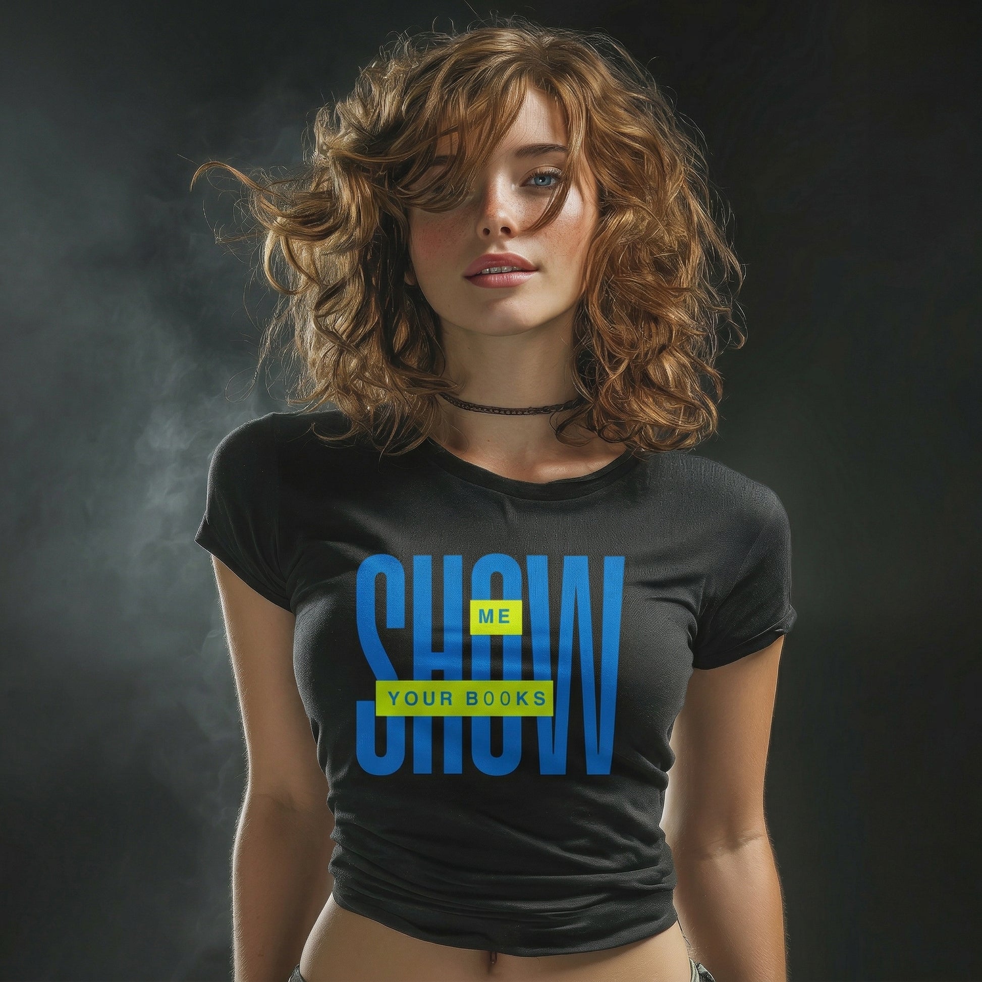 Woman wearing a black t-shirt with blue and yellow text "show me your books" against a dark background