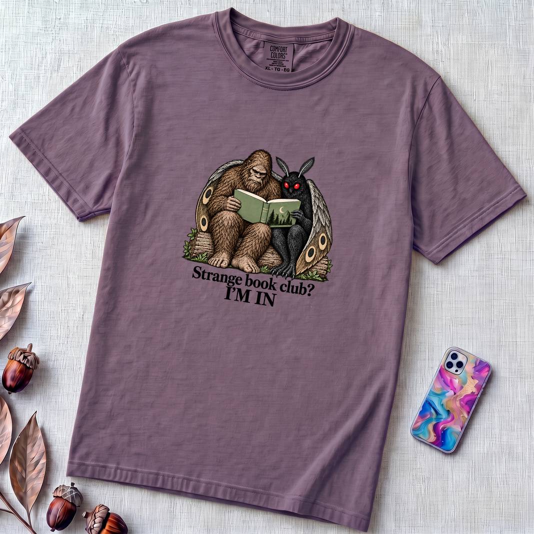 Strange Book Club? I’m In,  Funny Cryptid T-Shirt, Bigfoot and Mothman are reading - Grape unfolded t-shirt mockup