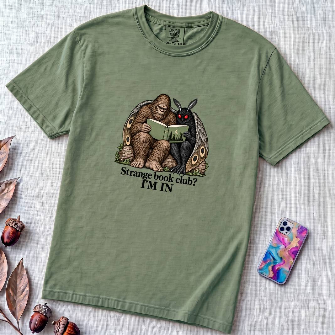 Strange Book Club? I’m In,  Funny Cryptid T-Shirt, Bigfoot and Mothman are reading - Light Green unfolded t-shirt mockup