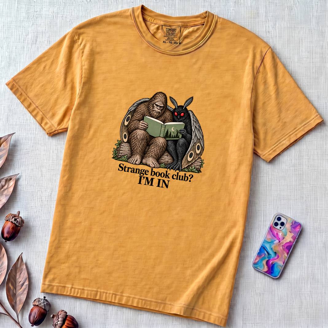 Strange Book Club? I’m In,  Funny Cryptid T-Shirt, Bigfoot and Mothman are reading - Mustard unfolded t-shirt mockup
