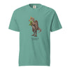 Teal t-shirt with a Spinosaurus mirabilis and a plush toy on a white background