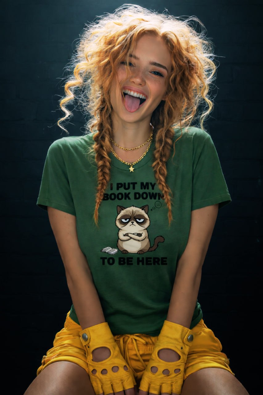 Woman with curly blonde hair in braids laughing with tongue out wearing green Grumpy Cat t-shirt "I Put My Book Down To Be Here"