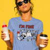 Woman with messy dark hair in bun and sunglasses wearing blue "I'm Fine" raccoon mom t-shirt with chaotic baby raccoons graphic