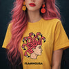 Woman with long pink hair wearing a yellow Flamingusa t-shirt featuring a flamingo Medusa graphic design