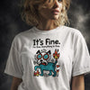 Woman with wavy blonde hair wearing white "It's Fine. I'm Fine. Everything Is Fine." t-shirt featuring stressed cartoon dog on fire meme graphic